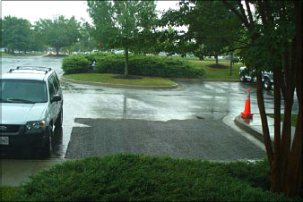 A rainy day shows pervious concrete with no water buildup at Draper Aden Associates