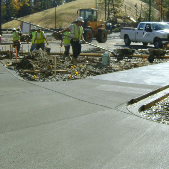 Finishing concrete sidewalks at the Reserves