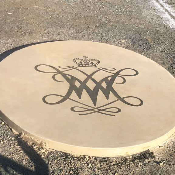 Custom bronze art embedded in specialized white concrete